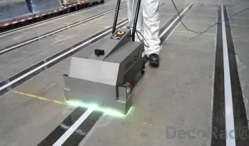 UV curing machine passing over freshly applied floor lines