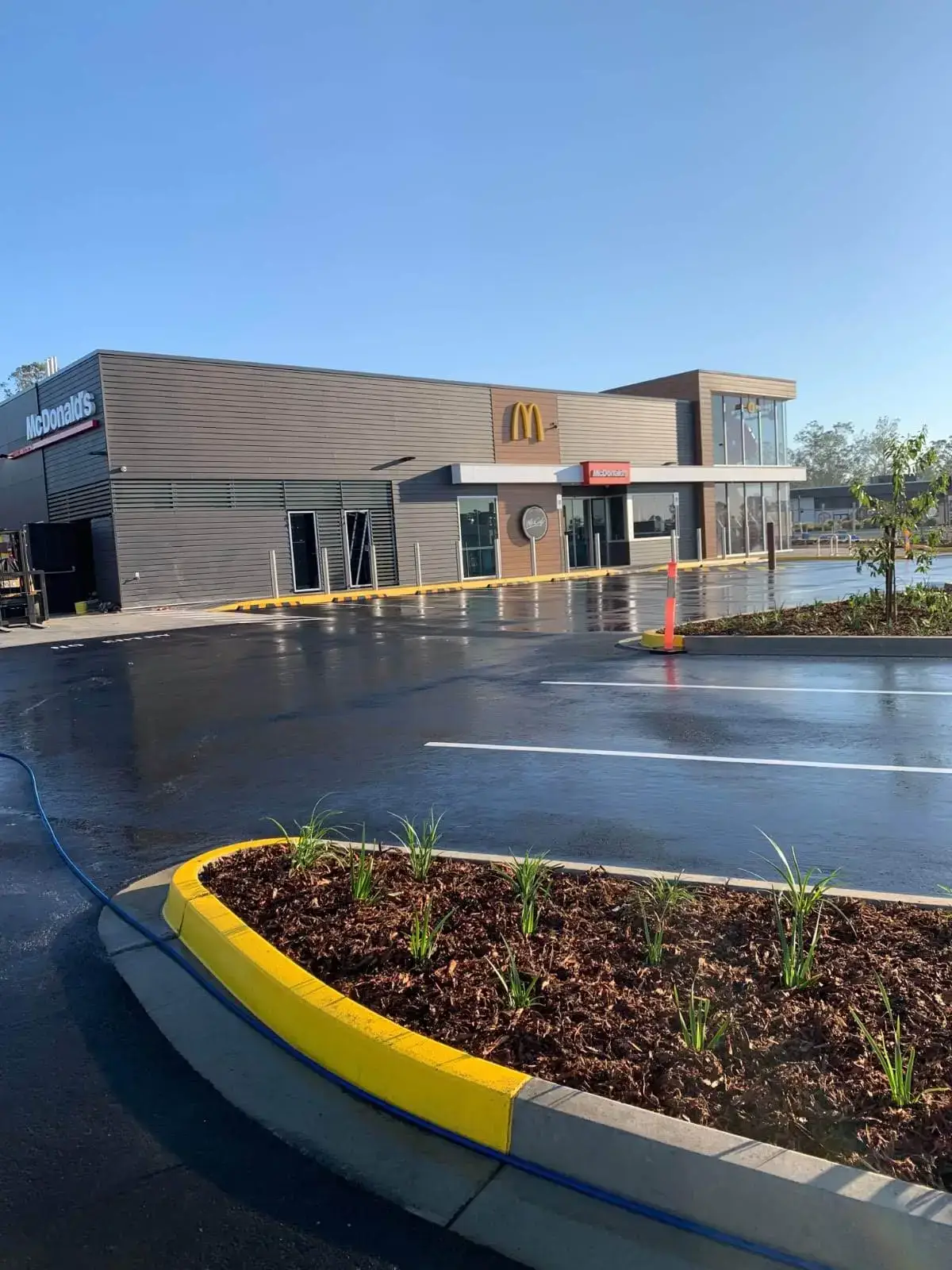 New fast food restaurant car park with fresh white bay lines and yellow garden bed edging