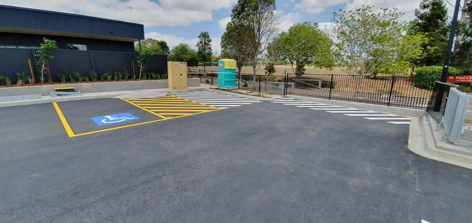Shopping centre car park with disabled bay, yellow chevron traffic calming and pedestrian crossing