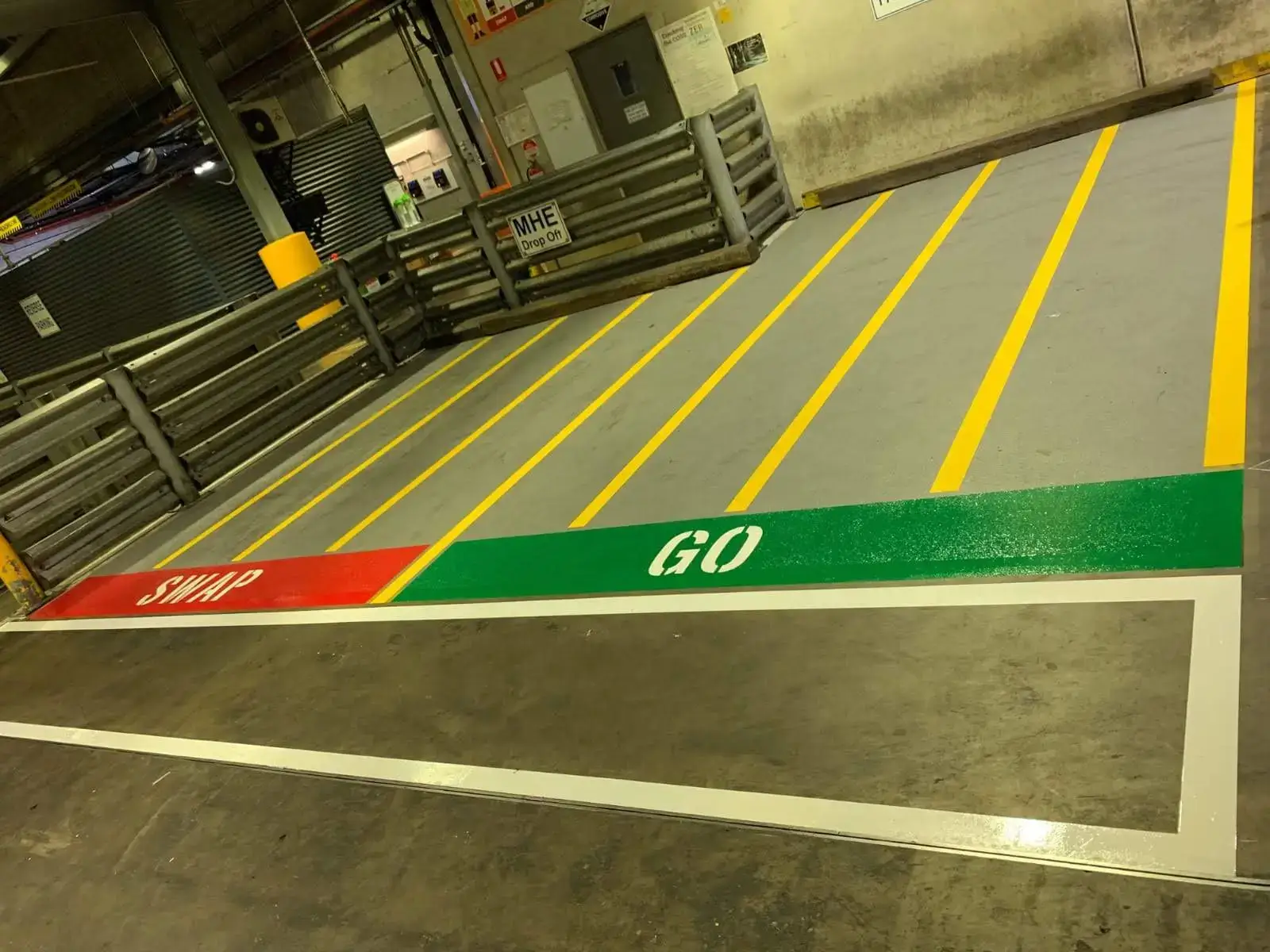 SWAP and GO battery charging station markings with yellow chevron striping