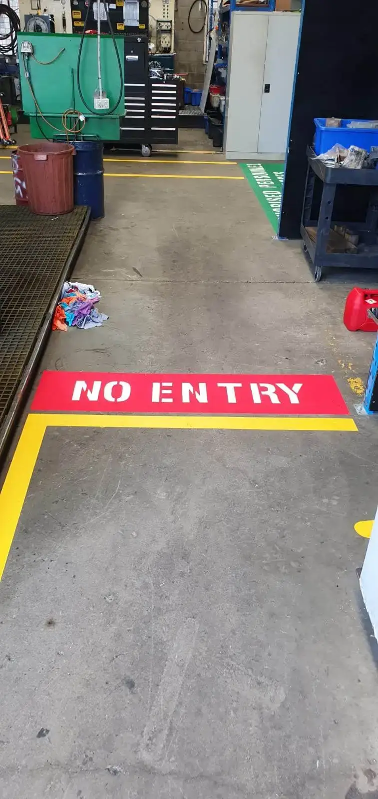Red NO ENTRY restricted area with yellow borders and green CHARGE POINT zone